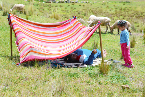 Preview: Happy Latin Woman With His Little Daughter Having Good Time In The Hovel Made Of Clothing. Relaxing