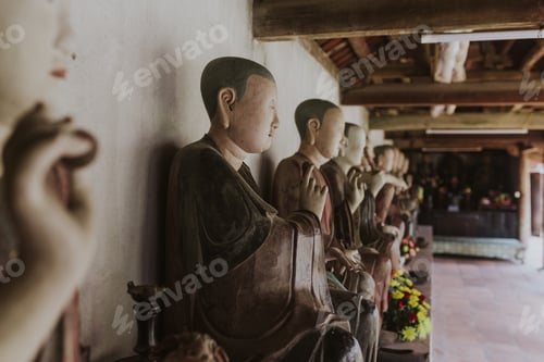 Preview: A Closeup Shot Of A Range Of Statues Of Males And Flowers In A Religious Building