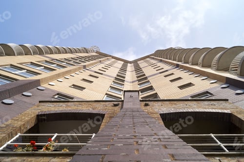 Preview: A Low Angle Shot Of A Residential Building Under Blue Sky