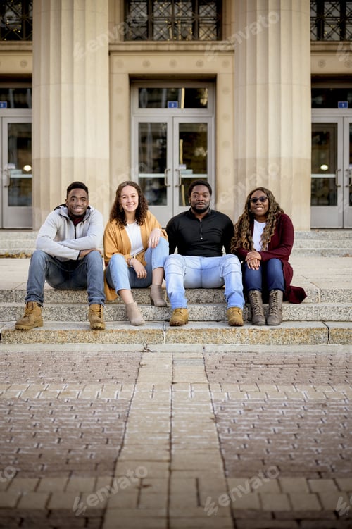 Preview: A Group Of People Sitting On The Stairs In Front Of A Building Under Sunlight