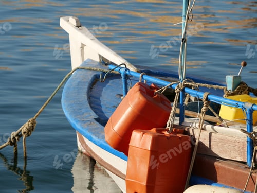 Preview: A Closeup Of Two Red Huge Empty Plastic Barrels Attached To The Boat In The Sea