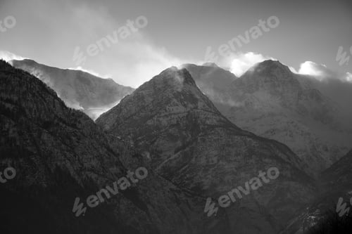 Preview: A Breathtaking Scenery Of The Snow-Capped Mountains Under A Scenic Cloudy Sky