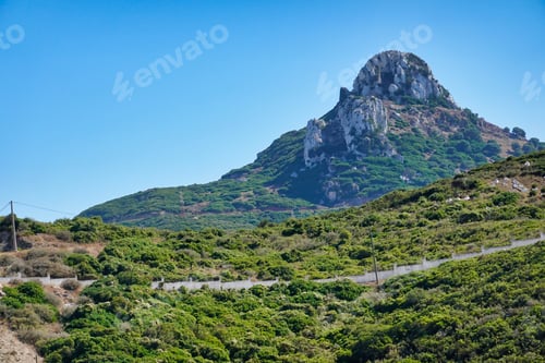 Preview: A Shot Of A Rocky Mountain Covered With Green Bushes