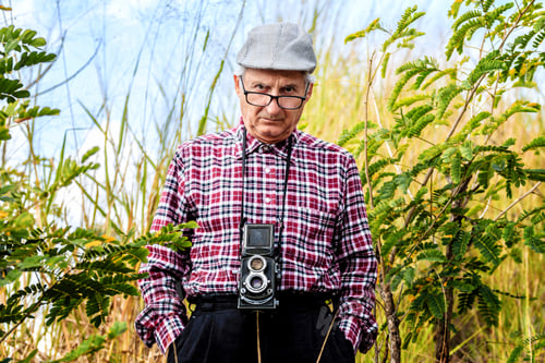 Preview: Senior Man Photographing Natural Landscape With Old Photographic Camera