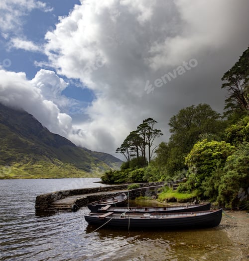 Preview: A Beautiful Shot Of Rowing Boats In The River Of Doo Lough, County Mayo In Ireland Under The Cloudy