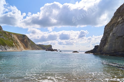 Preview: A Beautiful Shot Of Durdle Door, Jurassic Coast Under Blue Sky And White Clouds