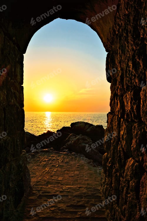 Preview: Setting Sun Through An Ancient Stone Archway Over The Mediterranean Sea