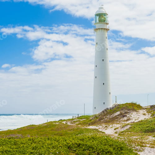 Preview: An Ancient Lighthouse On A Grassy Shore Under A Beautiful Cloudy Sky In Cape Town, South Africa