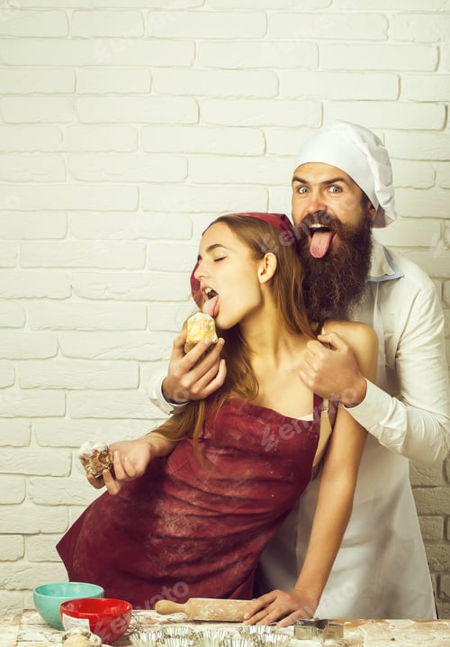 Preview: Bearded Handsome Man, Baker Or Cook Feeds Sweet Cakes To Winking, Pretty Girl Or Beautiful Woman In