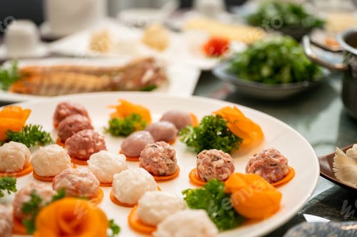 Preview: A Closeup Of A Different Type Of Meatballs On A Round White Plate With Blurred Background