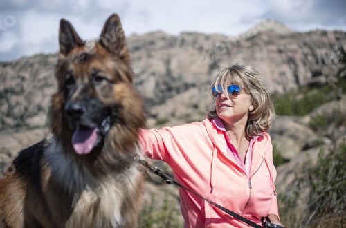Preview: A Female Hiker Resting With Her Dog And Enjoying The Fresh Air