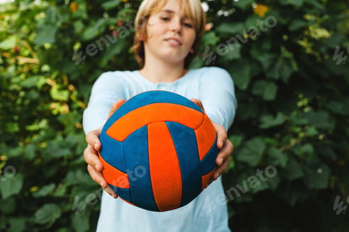 Preview: Happy Teenager With Ball In His Hand , Smiling And Looking At Camera, Outside In Park