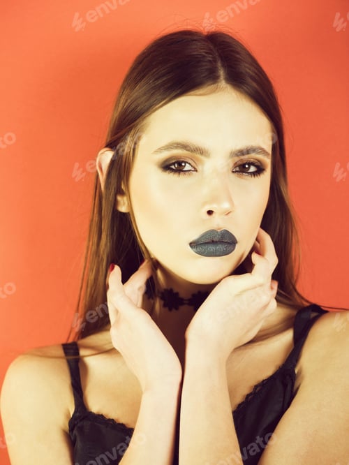 Preview: Glamorous Woman with Dramatic Makeup on Orange Background