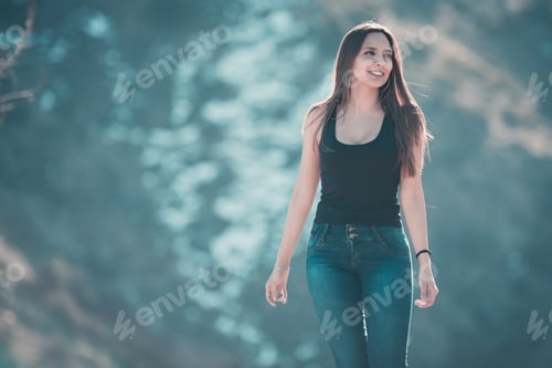 Preview: Beautiful Young Woman Walking On The Mountain With A Winter Background