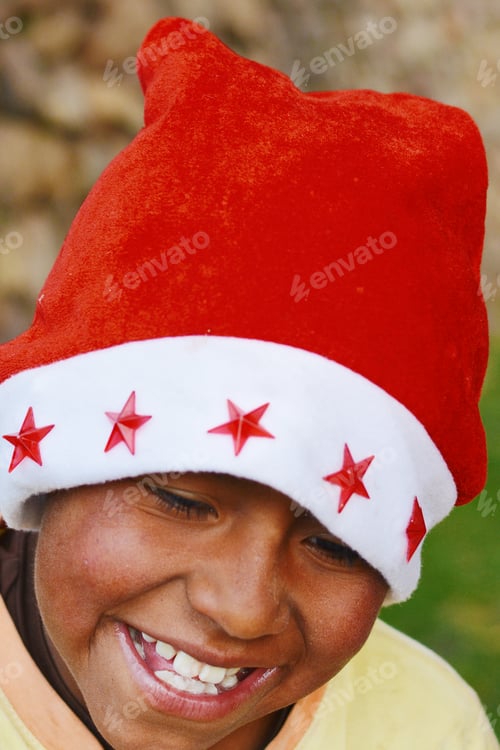 Preview: Happy Native American Boy Wearing Typical Red Santa Claus Hat.