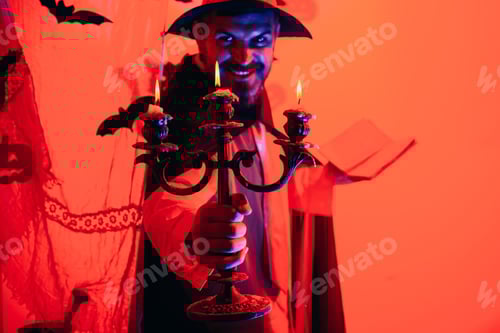 Preview: Scary Face Man With Horror Make Up Holding Pumpkin Head Jack Lantern On Sky Background. Halloween