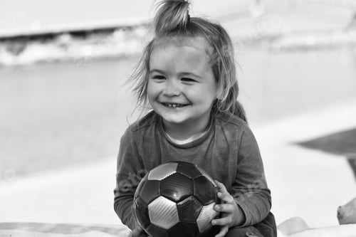 Preview: Little Cute Happy Smiling Boy Kid With Long Blond Hair Holding Multicolored Ball Sitting On