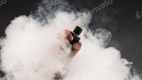 Preview: Hand Of Man Soars On The Smoke With Mod In A Black Background. Vape Concept