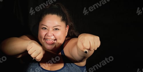 Preview: Happy Overweight Woman In Sportswear On A Black Background