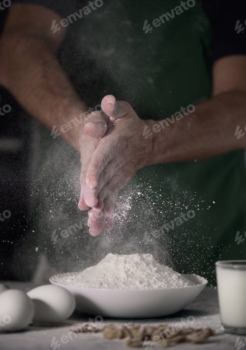 Preview: A Vertical Shot Of A Cook Cleaning His Hands From Flour