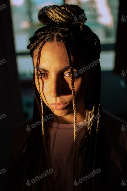 Preview: A Closeup Portrait Of An Attractive Hispanic Woman With Long Braided Hair And Sunbeam On Her Face