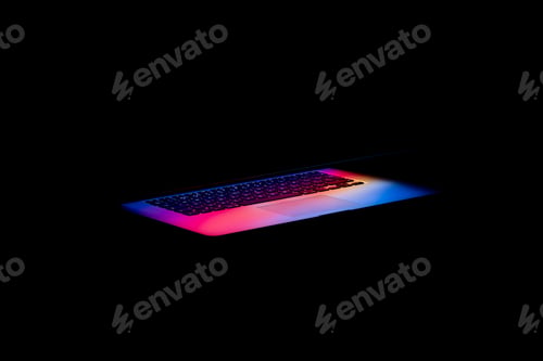 Preview: A Colorful Light Coming Out Of A Laptop Screen In The Darkness