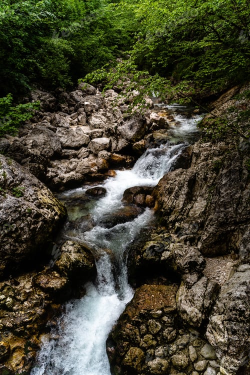 Preview: A Vertical Shot Of A Beautiful Small Waterfall In The Park Of Triglav, Slovenia In The Daytime