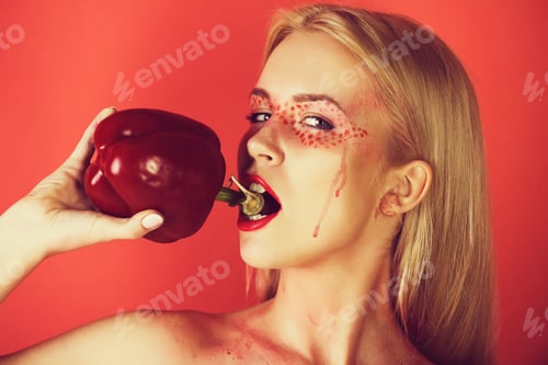 Preview: Paprika In Hand Of Pretty Blonde Woman With Creative Fashionable Makeup On Face Hold Sweet Bell