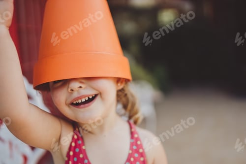 Preview: Cute Little Girl Playing At Home Wearing A Fun Hat