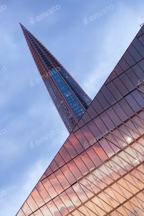 Preview: A Vertical Low Angle Shot Of A Laktha Center Reflecting The Sunset In Russia