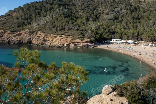 Preview: The Sea Surrounded By The Beach And Hills Covered In Greenery Under The Sunlight In Ibiza In Spain