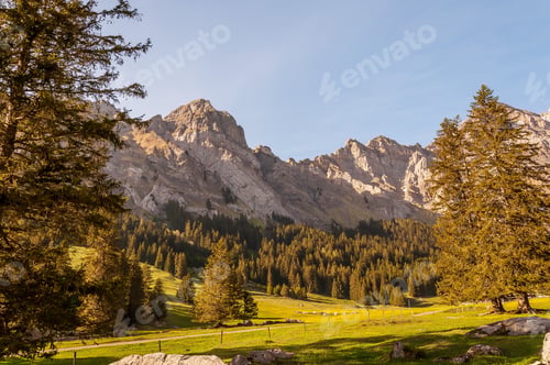 Preview: A Beautiful Mountainous Landscape With Greenery And Mountains In The Swiss Alps
