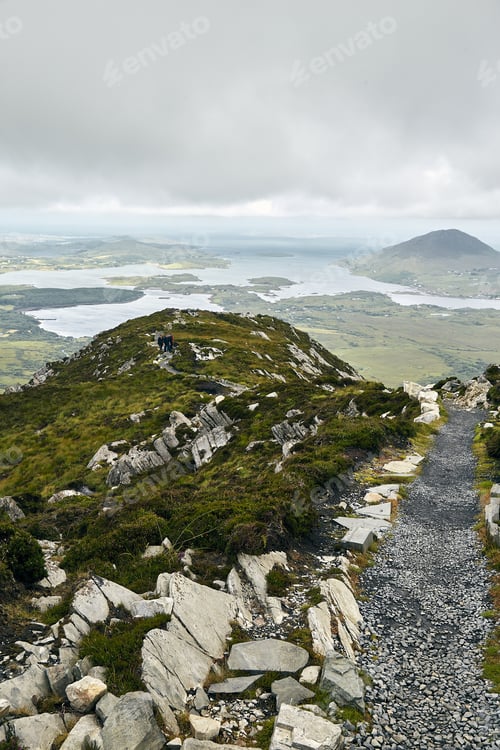Preview: A Vertical Shot Of A Narrow Pathway In Connemara National Park In Ireland Under A Cloudy Sky