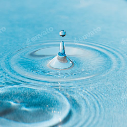 Preview: A Closeup Shot Of A Water Droplet In The Blue Water