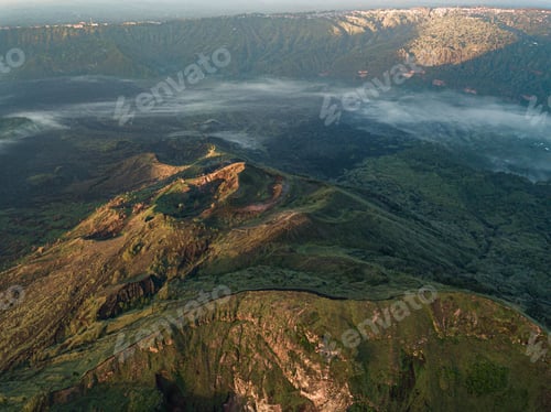 Preview: A Bird'S Eye View Of Hills Covered In Greenery And Fog Under The Sunlight - Perfect For Wallpapers
