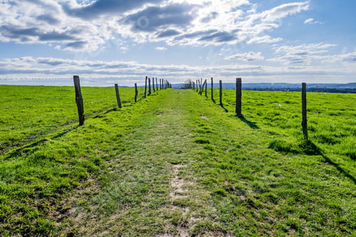 Preview: A Vast Green Valley With A Blue Sky During Daytime