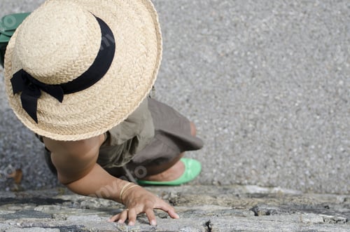 Preview: A High Angle Shot Of A Female With Straw Hat And Green Shoes Leaning On The Wall