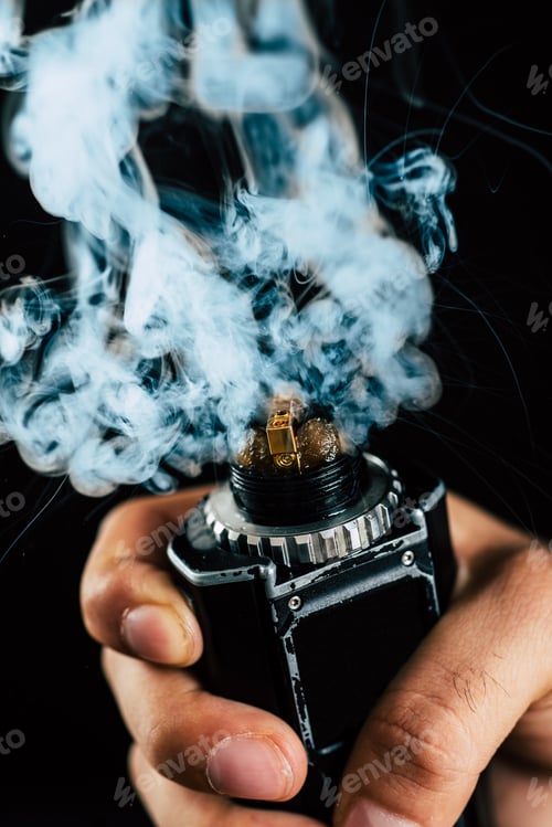 Preview: Electronic Cigarette Mechanical Mod Closeup . A Lot Of Steam . Centered On A Black Background