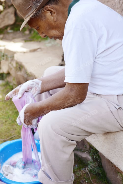Preview: Elderly Native American Man Washing Clothes In The Countryside.