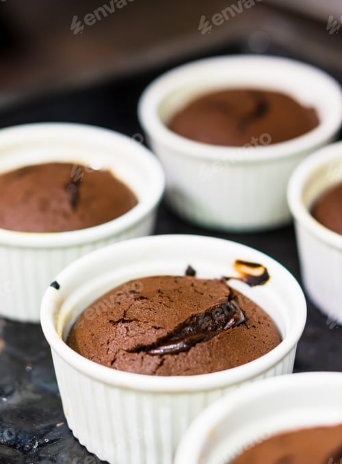 Preview: A Vertical Selective Focus Shot Of Chocolate Puddings In White Cups