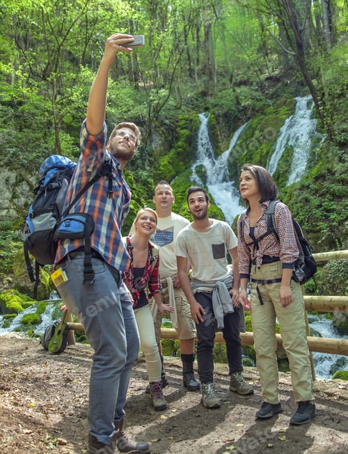 Preview: A Group Of Friends Having Fun And Taking Selfies In Front Of A Waterfall