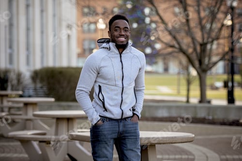 Preview: A Portrait Of A Smiling African-American Man In A Park Under Sunlight With A Blurry Background