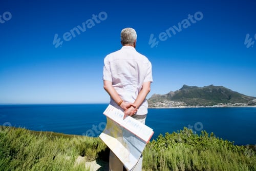 Preview: South Africa, Cape Town, Senior Man Holding Map, Looking Out To Sea, Rear View