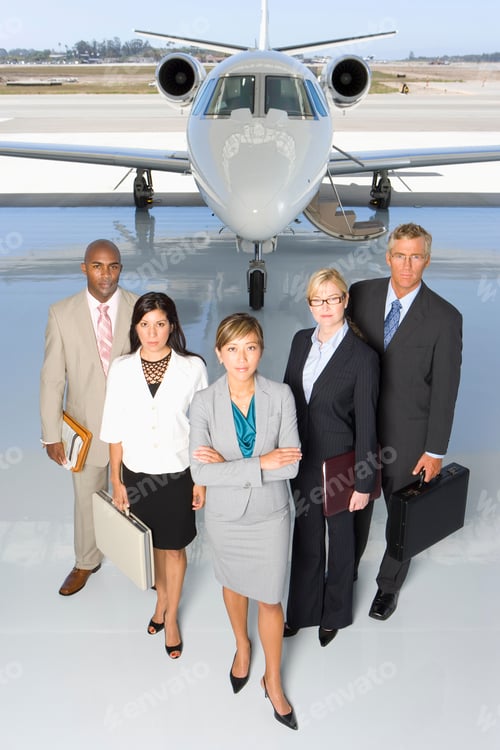 Preview: A Small Group Of People Standing In Line Behind A Woman In Front Of A Private Jet.