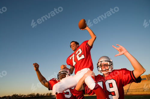 Preview: Low Angle View Of Smiling American Football Players In Red Football Jersey Celebrating Victory