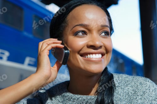 Preview: Horizontal Head And Shoulder Portrait Of A Smiling Woman Talking On A Mobile Phone At The Train