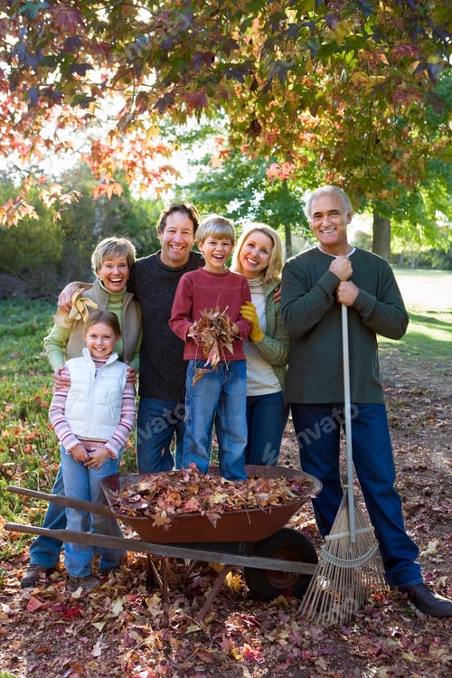 Preview: Vertical Shot Of A Couple With Two Kids And Their Grandparents Standing In Garden With Boy In A