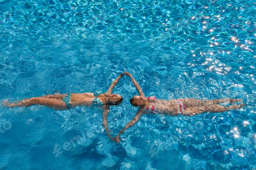 Preview: Two Teenage Girls Having Fun In The Swimming Pool On A Sunny Day.
