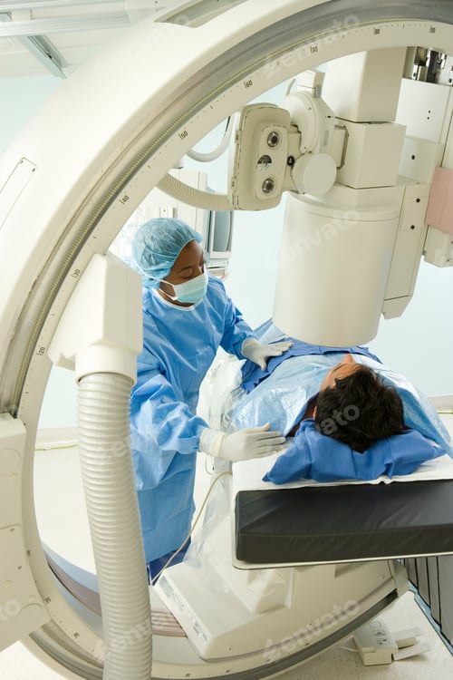 Preview: Vertical Shot Of A Doctor Preparing A Patient Lying Down On A Bed For An X-Ray In The Hospital
