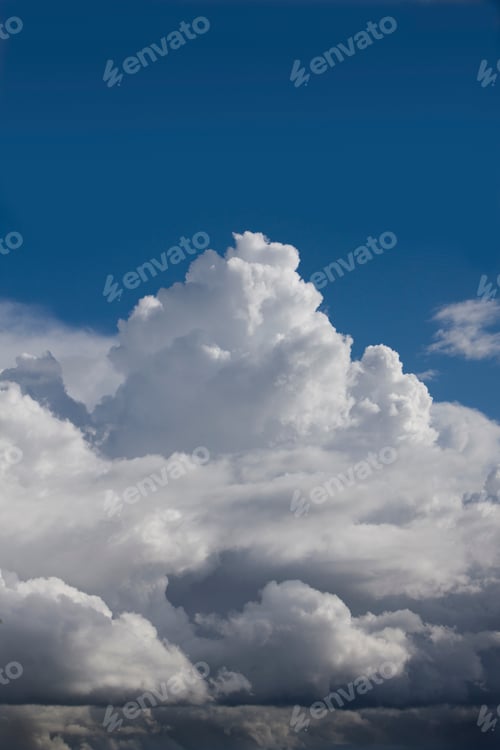 Preview: Vertical Shot Of Summer Bright Blue Sky With Fluffy Clouds.